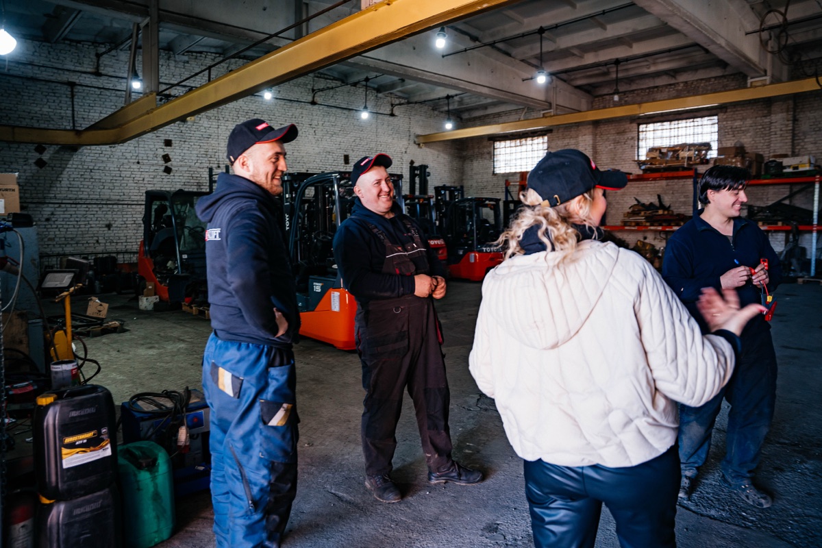 Команда IMPEX Forklift с клиентами в сервисном цехе